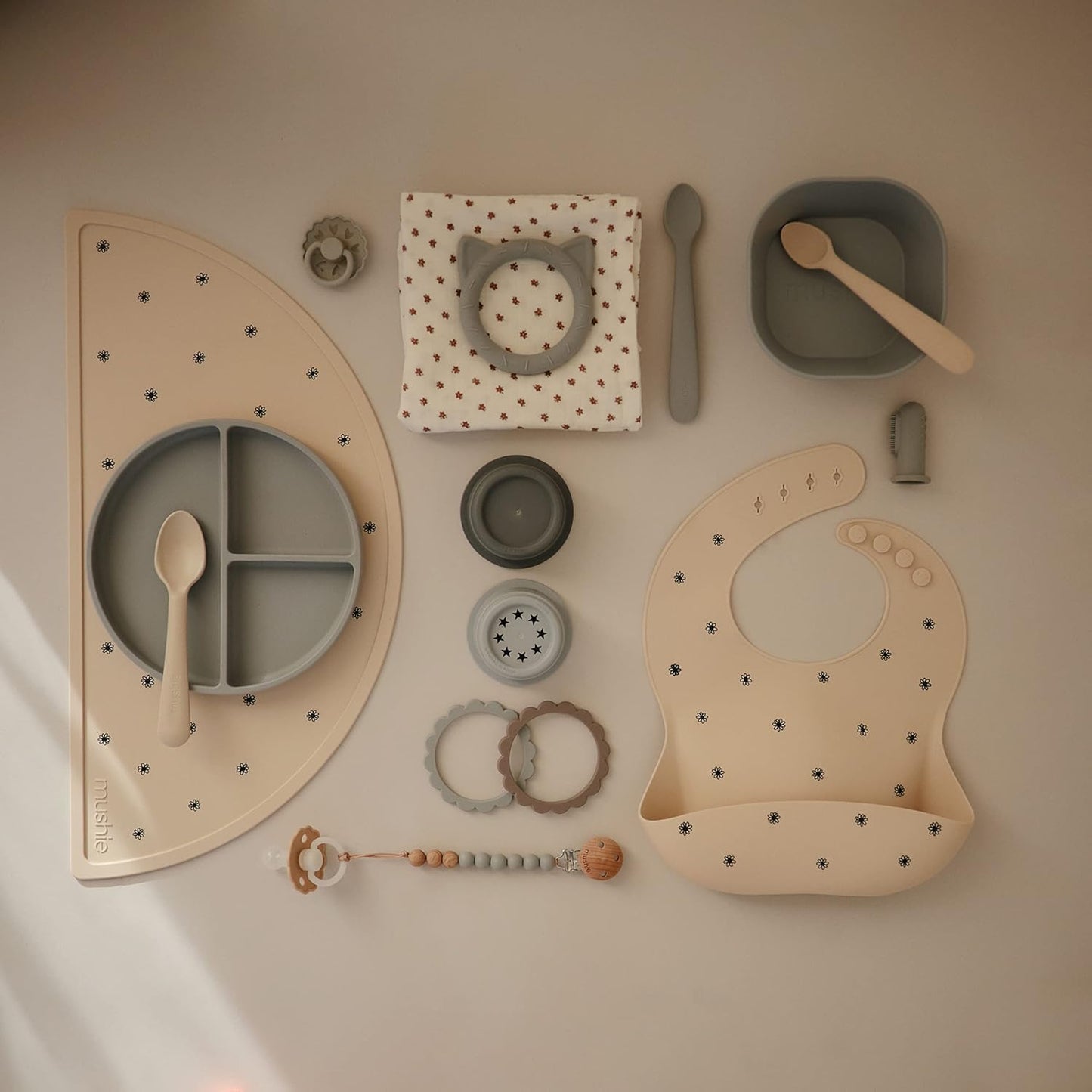 mushie Silicone Baby Bib | Adjustable Fit Waterproof Bibs (Black Daisy)